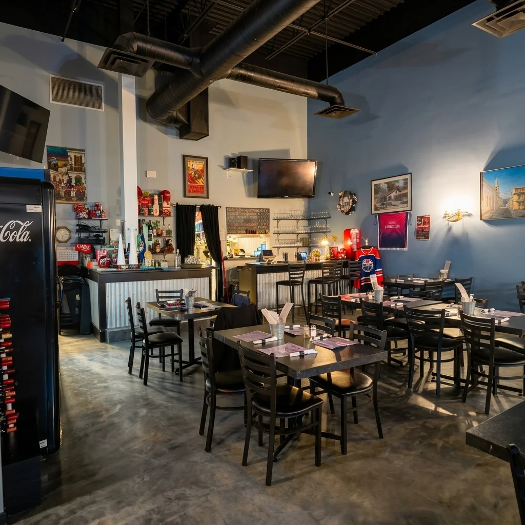 La Boca Loca dining room with dark tables, place settings and framed art